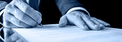 close up shot of someone signing a document.